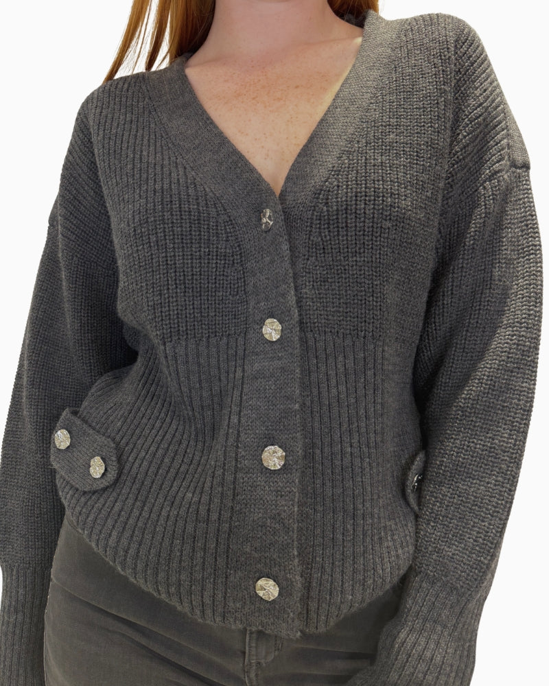 Close-up of button fastening on dark grey Eva Kayan cardigan
