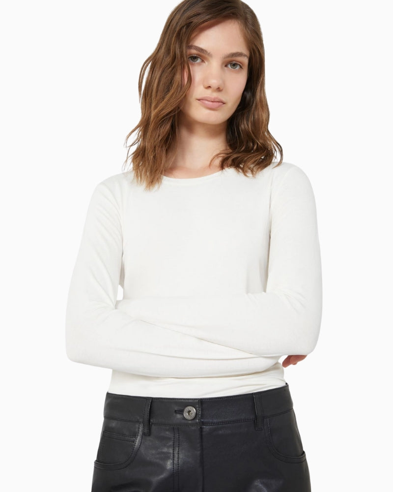 Model wearing cream Weekend Max Mara top with black skirt