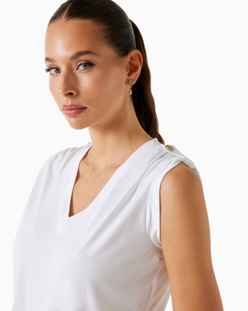 Close up view of white jersey V-neck top by GUESS with buttoned epaulettes
