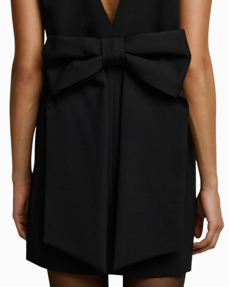 Back view of black mini blazer dress with V-cut and bow detail