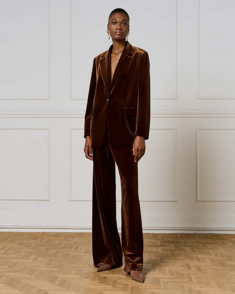Model wearing jacket with matching trousers for a full velvet look
