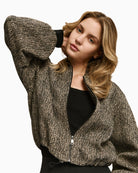 Close-up of sleeve showing rhinestone embellishment and ribbed cuff finish