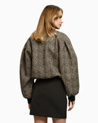 Back of herringbone bomber jacket with adjustable drawstring hem and structured shape