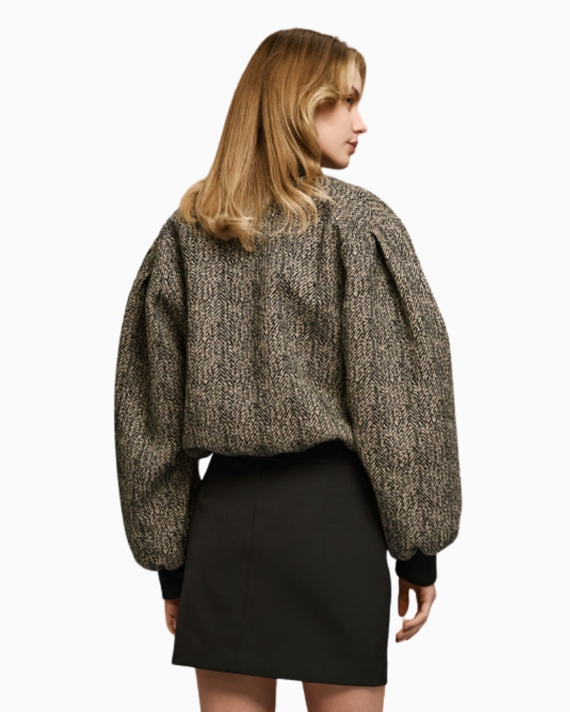 Back of herringbone bomber jacket with adjustable drawstring hem and structured shape