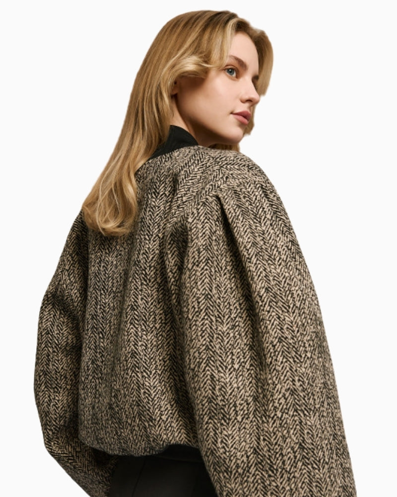 Side view of wool-blend cropped bomber showing puff sleeve and rhinestone detail