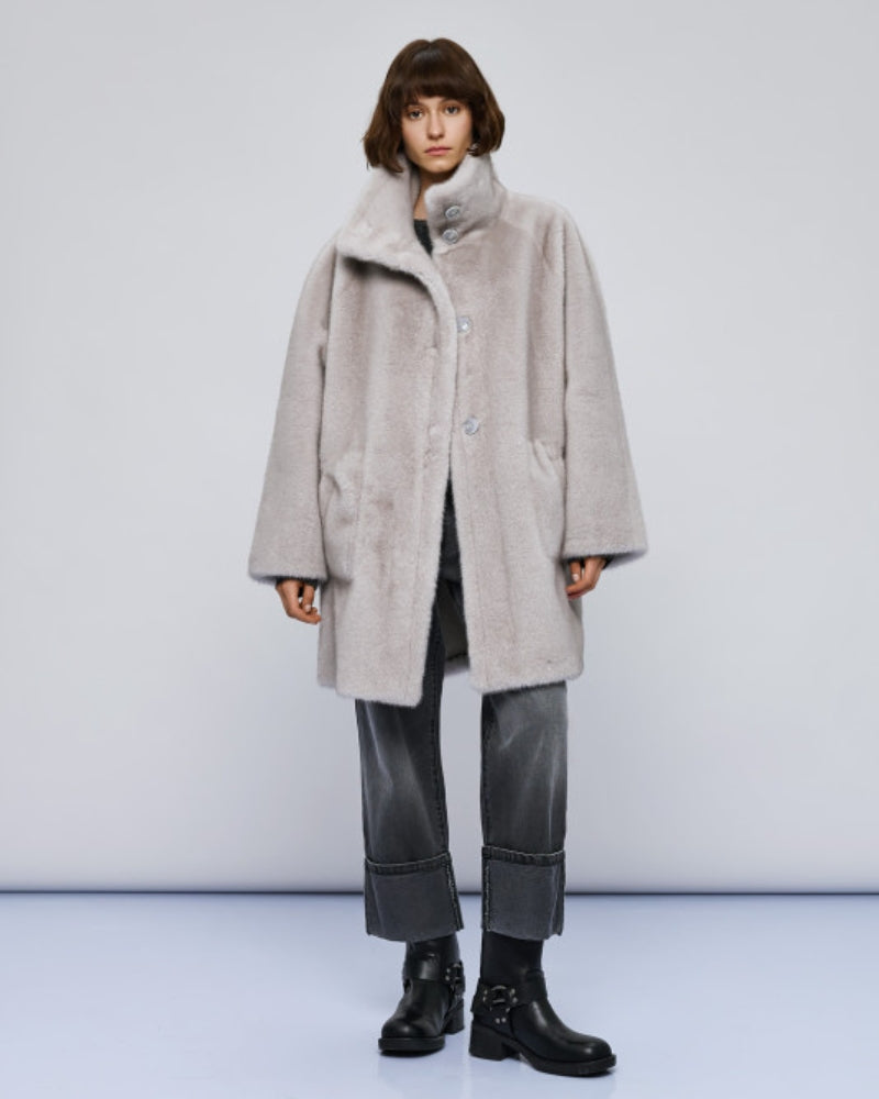 Model styling coat with formal trousers and heels