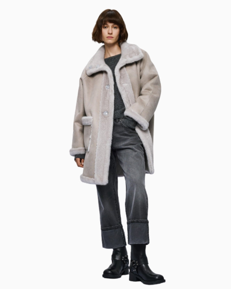Model styling coat with formal trousers and heels