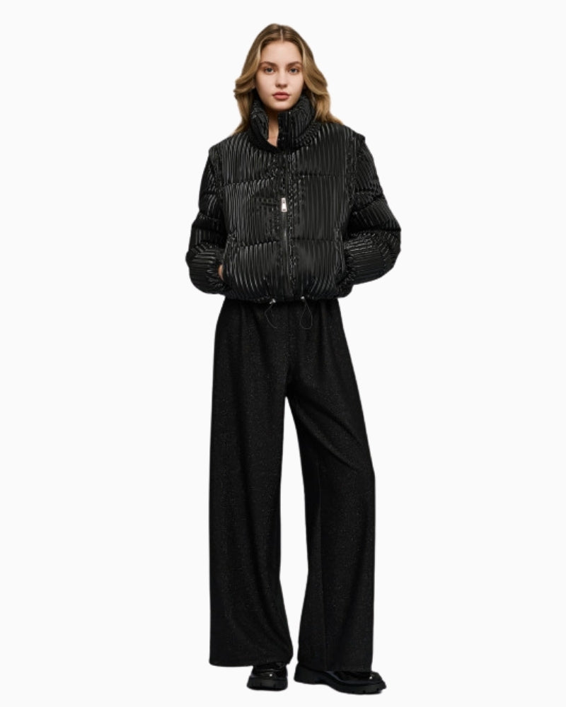 Model wearing black puffer jacket styled with jeans and boots