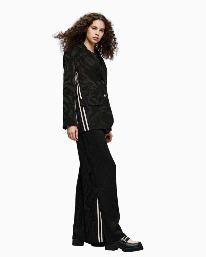 Full look with model wearing black jacquard trousers by Access with matching blazer