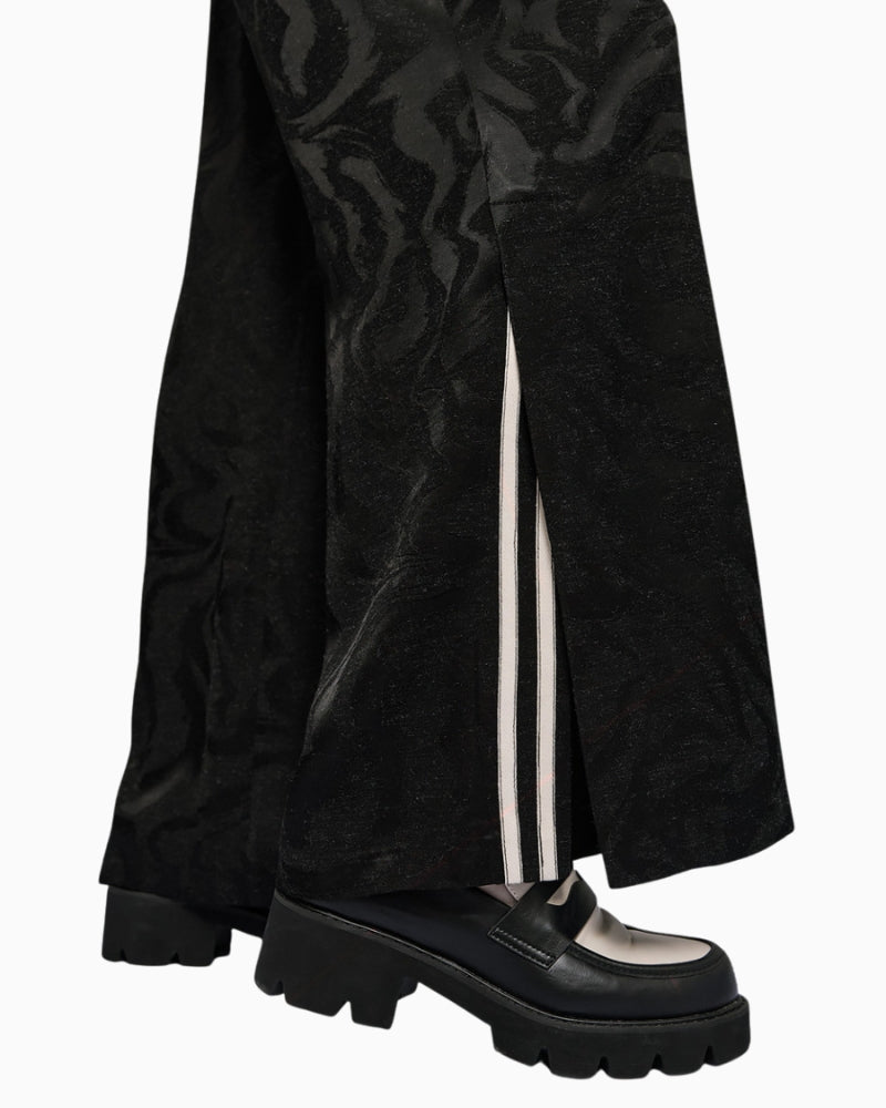 Close-up of jacquard fabric texture and striped trim at side slit