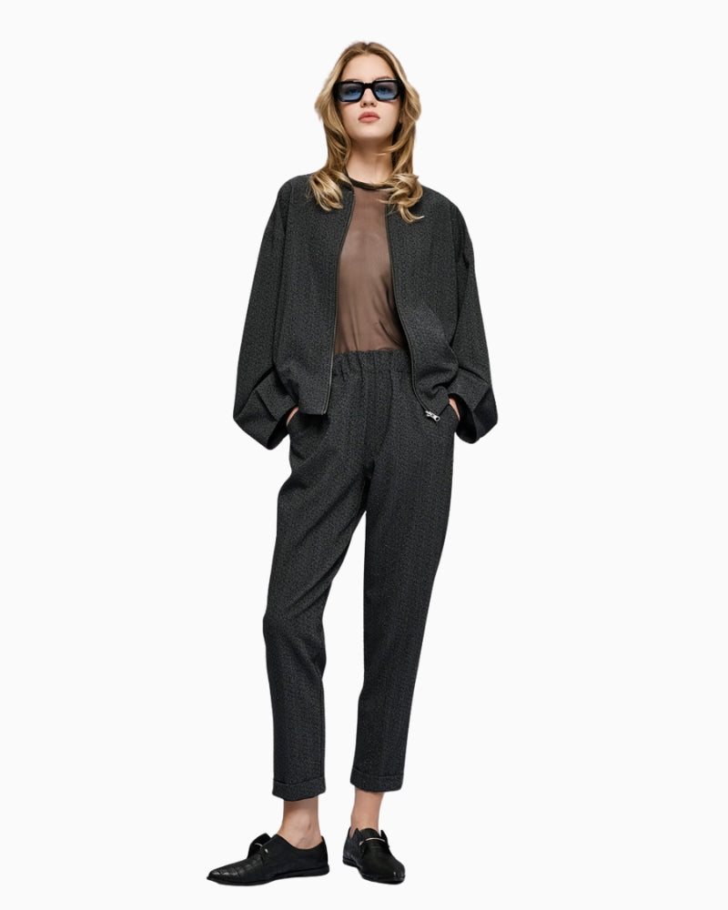 Front view of high-waist pants with rhinestones, turn-up hems and side pockets