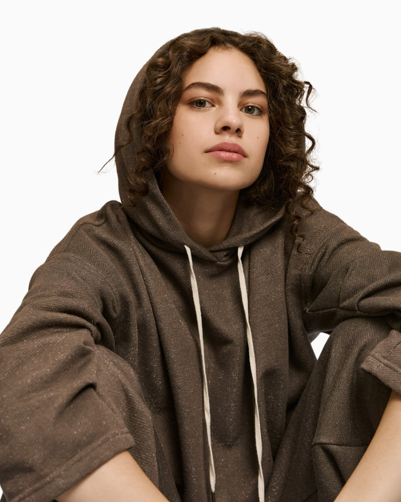 Close-up of metallic thread detail and pleated sleeve on Access sweatshirt