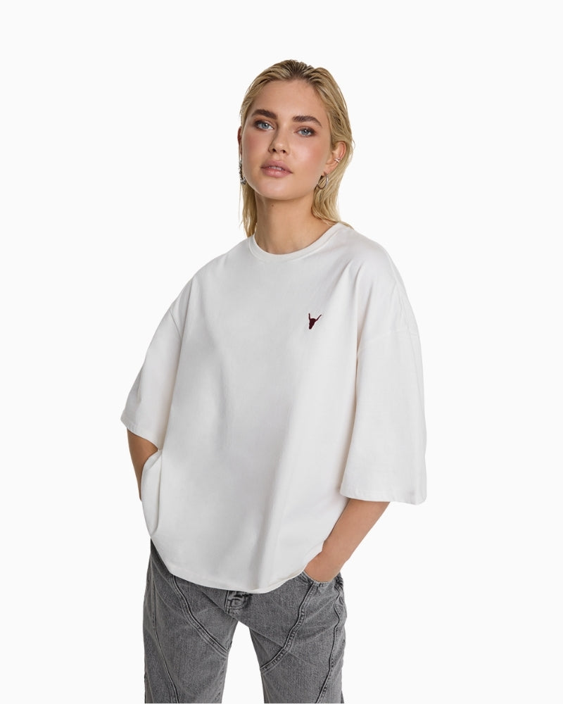 Soft white Alix The Label T‑shirt with ‘THE LABEL’ logo across back