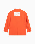 Back view of Alix flowy blazer in orange with bold ALIX THE LABEL print