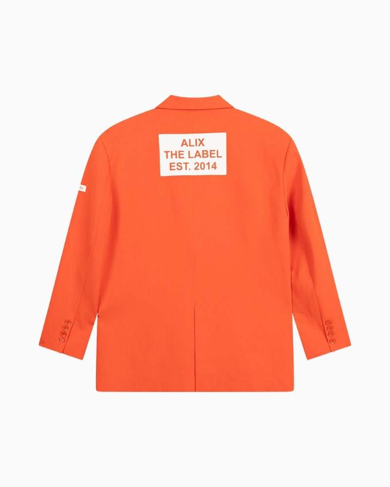 Back view of Alix flowy blazer in orange with bold ALIX THE LABEL print