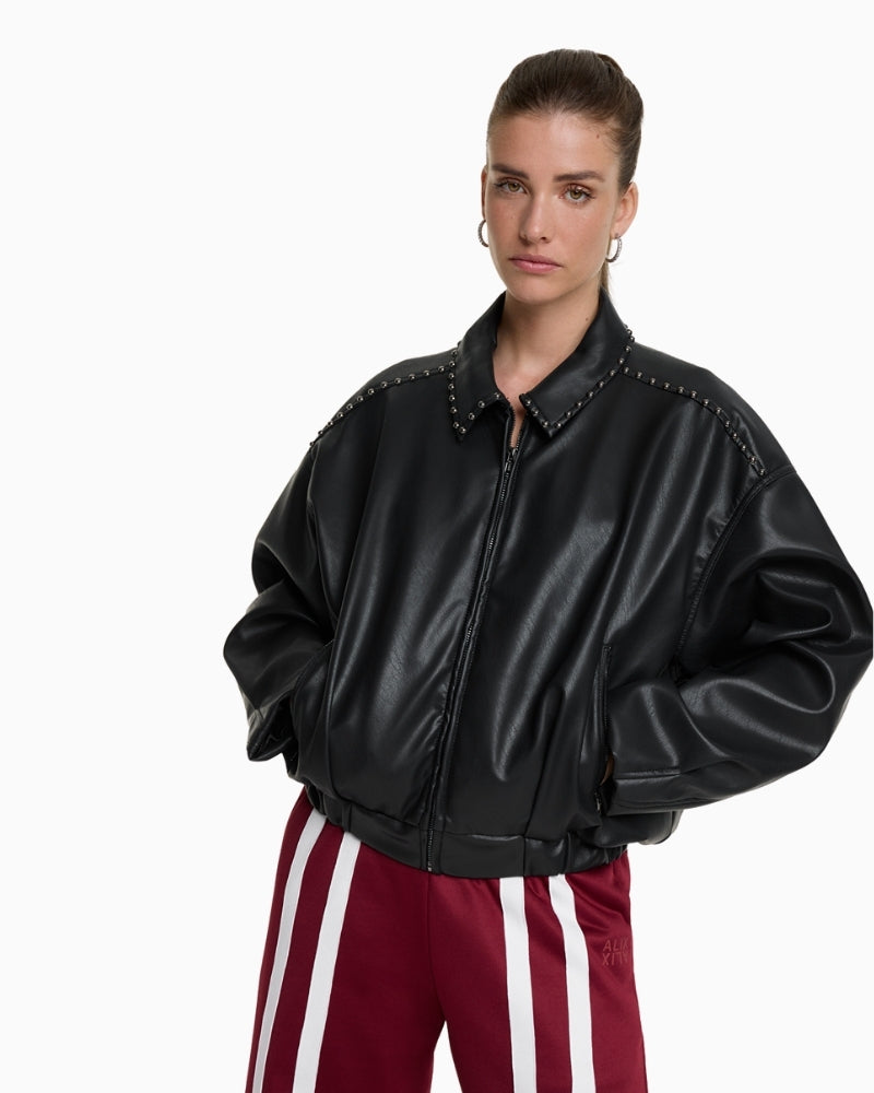 Model wearing cropped faux leather bomber jacket with front zip and pockets