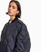 Close-up of bull embroidery on sleeve and textured quilted fabric