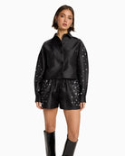 Model wearing satin studded shirt with button front and long sleeves