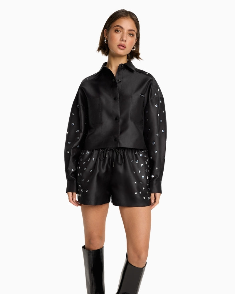 Model wearing satin studded shirt with button front and long sleeves