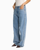 Soft denim blue straight‑leg jeans with front studs by Alix The Label