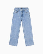 Detail of studs and wash effect on front of denim pants Alix