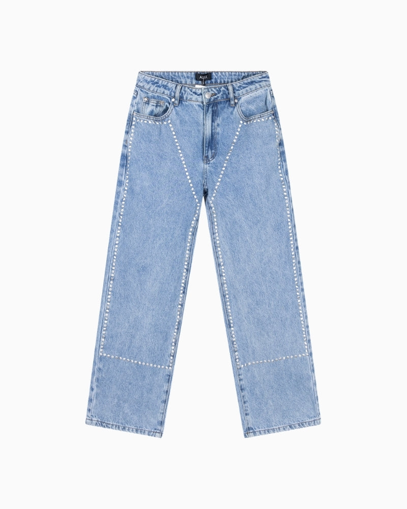 Detail of studs and wash effect on front of denim pants Alix