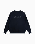 Back view of Alix V-neck sweater showing subtle ALIX artwork