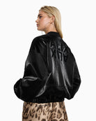 Back of ALIX bomber jacket featuring mirrored ALIX logo and cracked leather texture