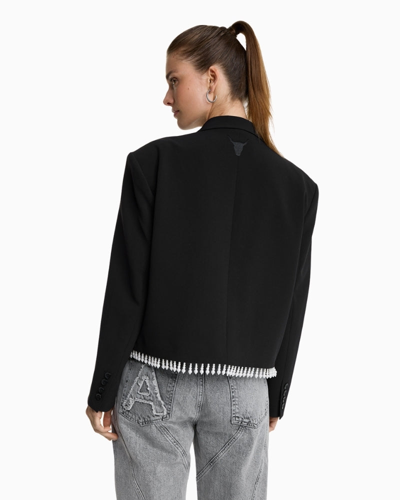 Back view of women's blazer with bull embroidery and soft draped fabric