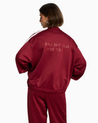 Back view of ALIX sweat jacket with large logo artwork and side stripes