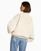 Back view of ALIX bomber showing mirrored logo and cracked leather texture