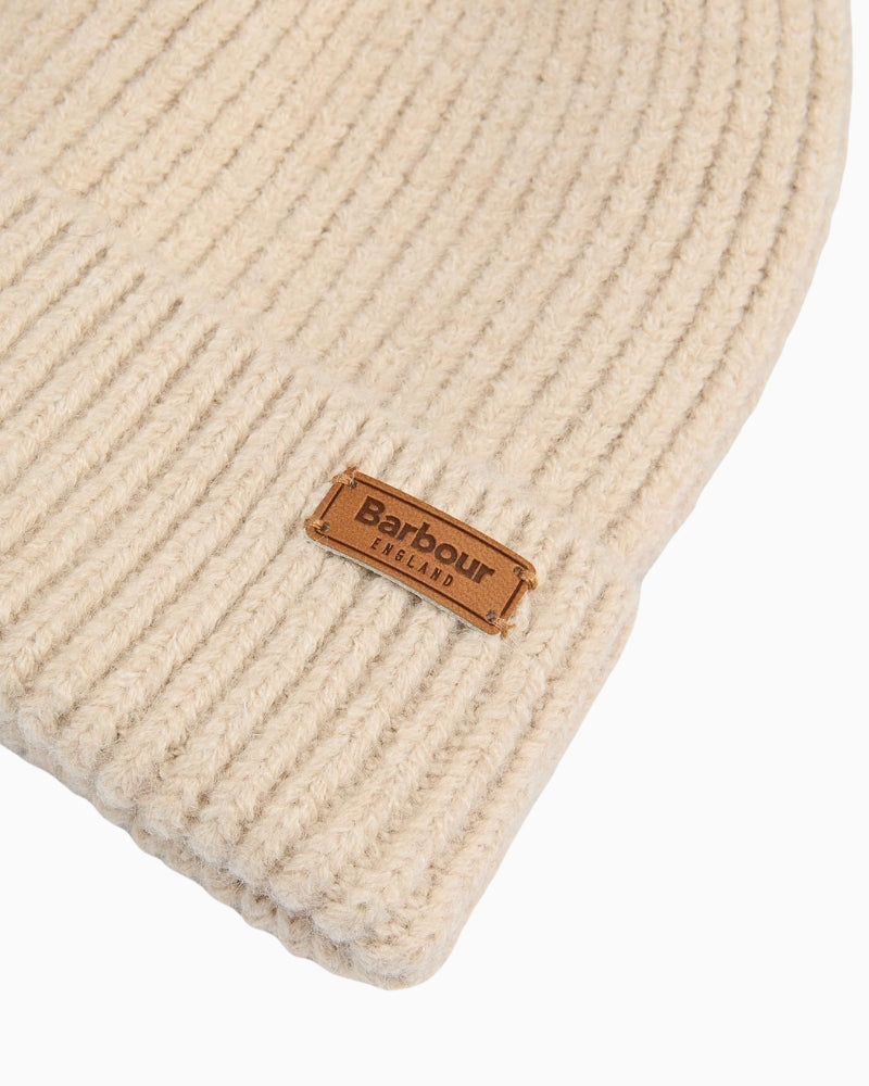 Close-up of Barbour beige knitted beanie with logo badge