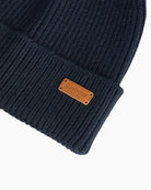 Close-up of Barbour faux fur pom beanie in winter knit