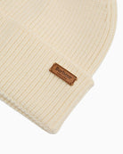 Close-up of faux fur pom on Barbour Dover beanie in monochrome knit