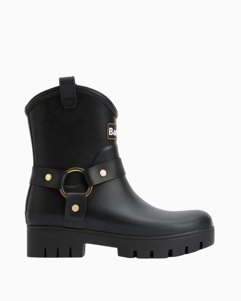 Side view highlighting harness strap and branded rivets on rubber upper