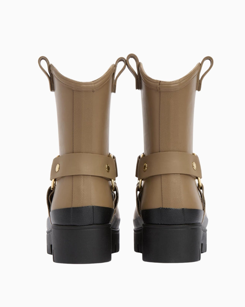 Rear of beige boot with pull tab and harness strap visible