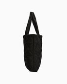 Side angle of Barbour Mariah Quilted Tote Bag in black showing slim depth