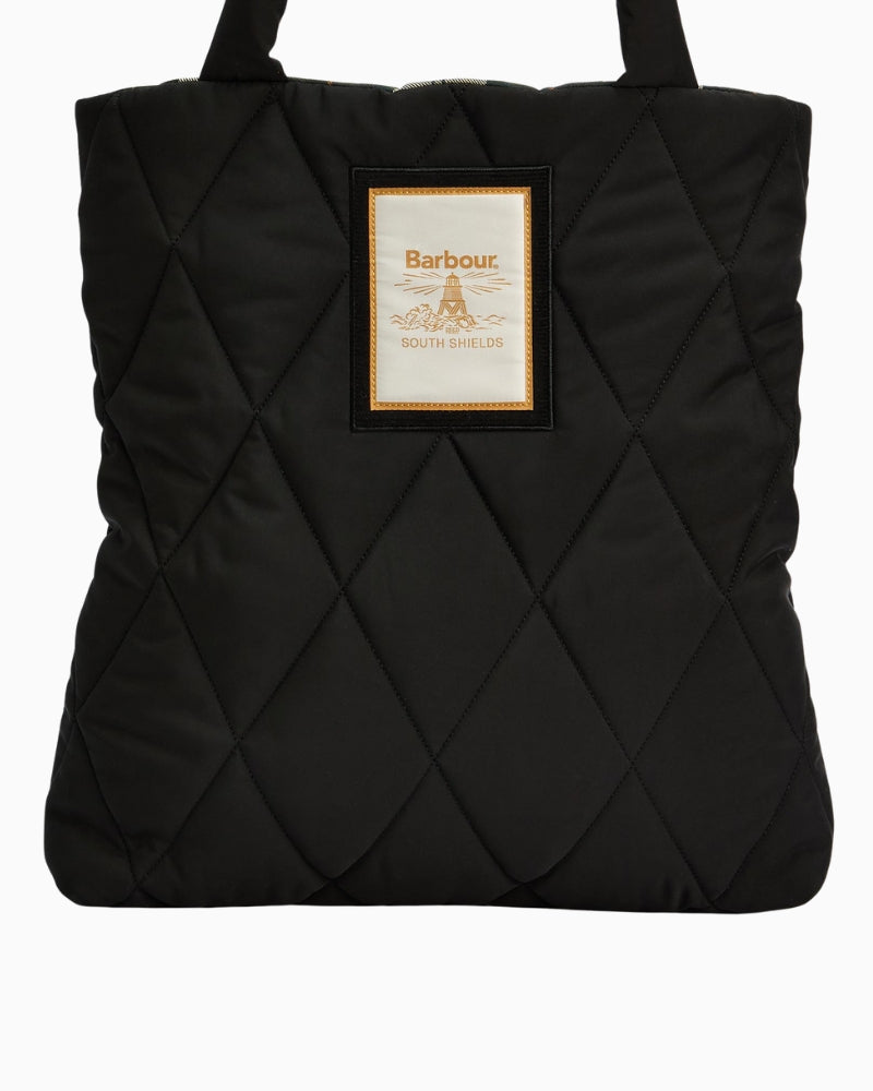 Close-up of Barbour Mariah Quilted Tote Bag logo patch and diamond stitching detail