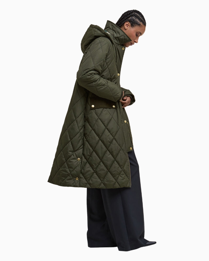 Side view of the olive Barbour jacket styled with jeans