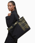 Lifestyle shot of Barbour Mya Patchwork Tote Bag carried with Barbour jacket