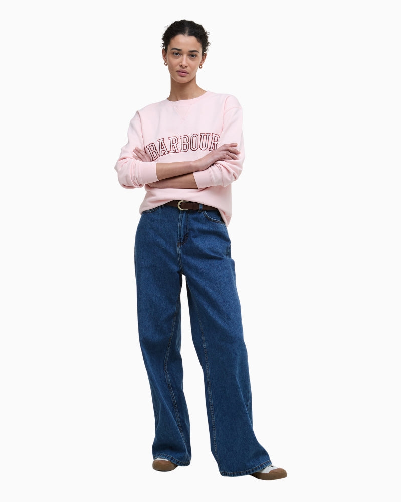Model wearing pink Barbour sweatshirt with jeans