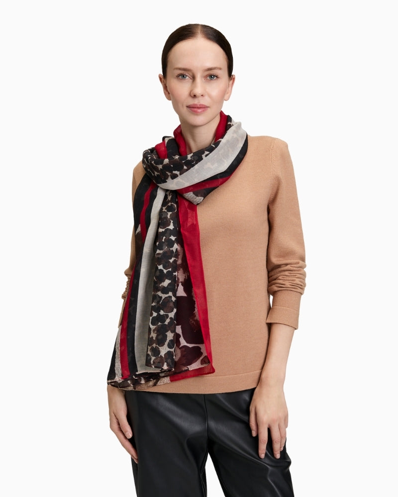 Draped scarf styled over shoulders showing flowy polyester fabric