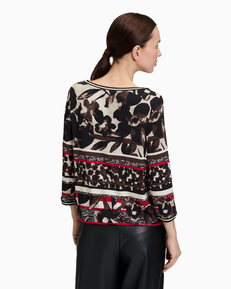 Back profile of jersey top showing figure‑skimming fit in soft floral pattern