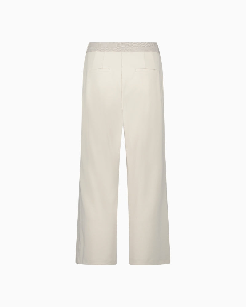 Back view of ¾ length wide-leg trousers showing relaxed drape and cropped fit