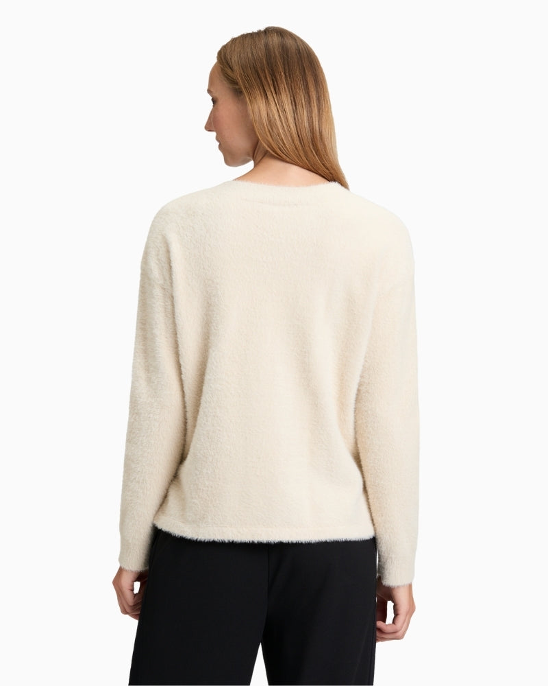 Back view of long-sleeve knit jumper showing relaxed fit and solid colour