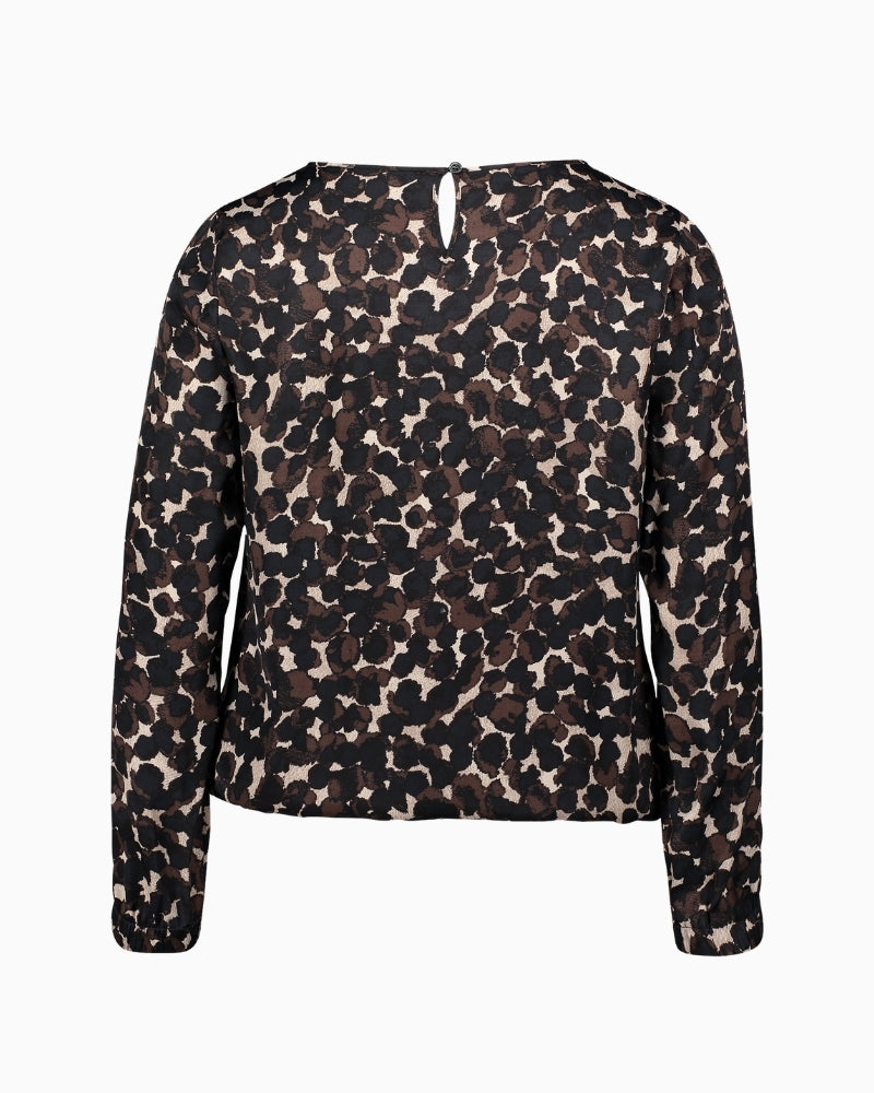 Back view with button loop fastening and relaxed polka dot pattern