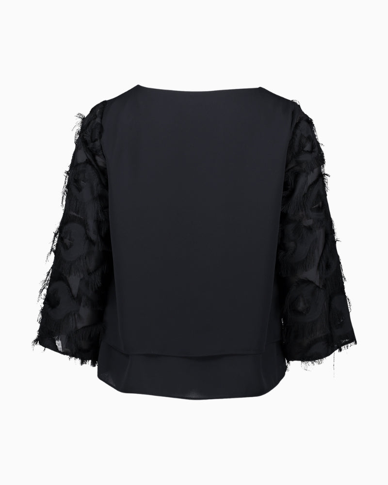 Back view of plain coloured overblouse with long sleeves