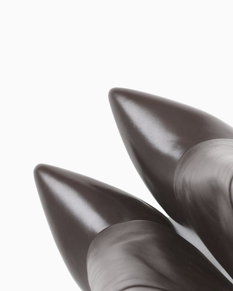 Close up of Tall brown leather skirt boots by BRONX with banana heel