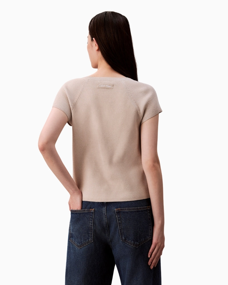 Back view of off-white sleeveless knit with ribbed trims