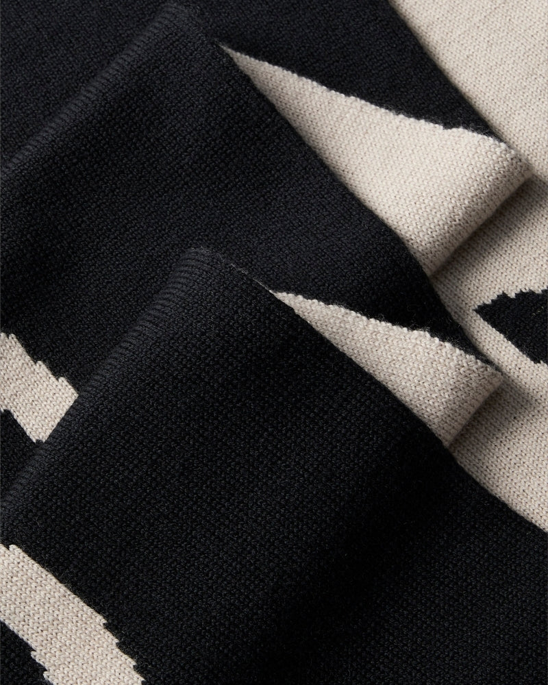 Close-up of CK logo on black and contrasting tone scarf